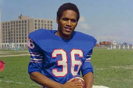 GM – FBF– Today’s American Champion is  an American former football running back, broadcaster, actor, advertising spokesman, and convicted felon.